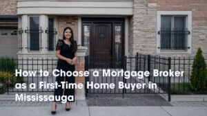 Mississauga mortgage broker Deepika Grover standing in front of a brick home with a dark wood door